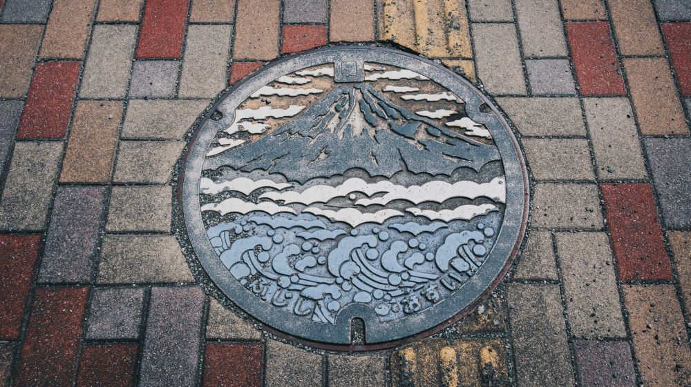 manhole with artistic design of mountain scene